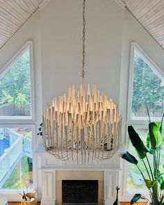 a large chandelier hanging over a fireplace in a living room