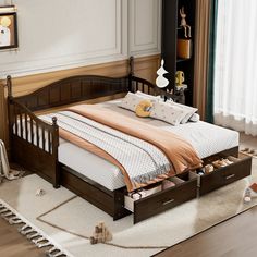 a bed with two drawers underneath it in a room next to a rug on the floor