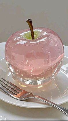 an apple is sitting on a plate next to a fork