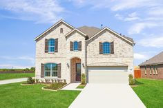 a large house with two garages in the front yard