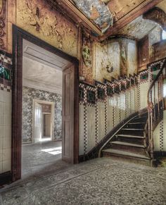 an old building with stairs and tiled walls