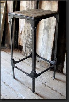 an old wooden table with metal legs