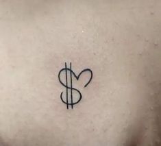 a heart and dollar sign tattoo on the chest