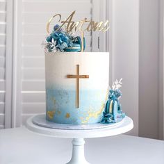 a blue and white cake with a cross on top