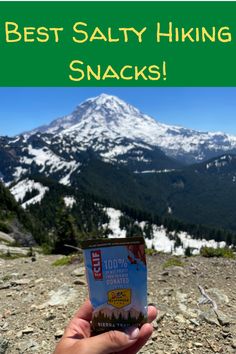 someone holding up a snack in front of a mountain with the words best salty hiking snacks