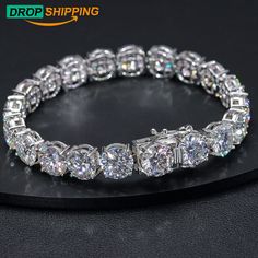 This glamorous moissante Diamond tennis bracelet is crafted in lustrous sterling silver. This alluring Ice Out bracelet features round with shimmering 10mm VVS tennis style jewelery Our bracelet is made with the greatest attention to quality and minutest details and enhances with a high polish finish, Its stunning sparkle design with precision craftsmanship gives you the best hiphop bracelet to wear and admire without being too loose This custom Cuban link moissanite bracelet is cheap but with h Dazzling Silver Moissanite Bracelets, Silver Moissanite Diamond Bracelet, Dazzling Silver Moissanite Diamond Bracelet, Silver Moissanite Diamond-cut Bracelets, Silver Moissanite Bracelet For Anniversary, Sterling Silver Moissanite Bracelet As Gift, Silver Moissanite Diamond Bracelet With Round Cut, Dazzling Diamond Cut Sterling Silver Bracelet, Silver Moissanite Diamond Bracelet With Brilliant Cut