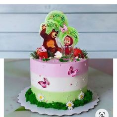 there is a cake decorated with animals and flowers