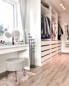 a white dressing room with lots of closet space