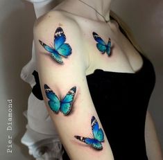 a woman with blue butterflies on her arm and shoulder, both showing the same color