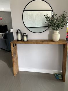 a wooden table with a mirror above it