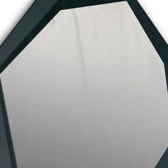 a black and white octagonal mirror on the wall