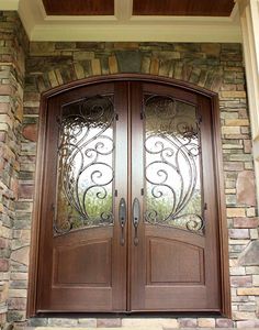 two double doors with decorative iron work on the front and side panels are shown in dark wood