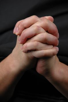 two hands holding each other in prayer