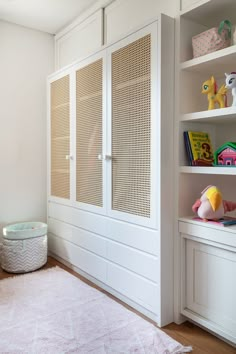 a child's bedroom with white closets and toys