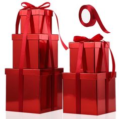 red gift boxes with ribbons and a bow on them, all stacked up against one another