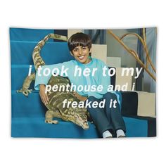 a young boy sitting on top of a blue set of stairs next to a lizard