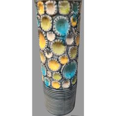 a ceramic vase with colorful designs on it