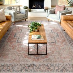 a living room filled with furniture and a fire place in the middle of the room