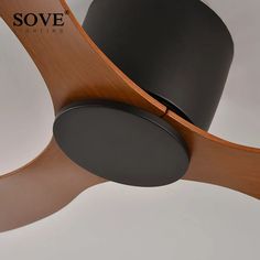 a wooden ceiling fan with a black top hat on it's blade and the word sove above it