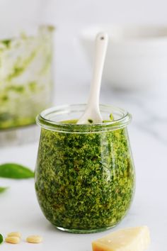 a jar filled with pesto and cheese