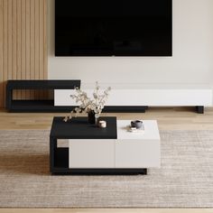 a white and black coffee table in front of a flat screen tv