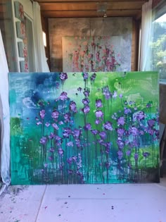 an easel with purple flowers painted on it