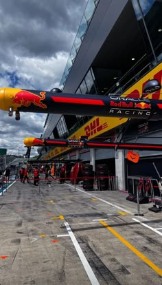 the red bull jet is on display at the race track in front of the building