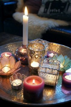 candles are sitting on a table with other items