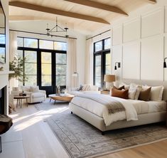 a large bed sitting inside of a bedroom on top of a hard wood floored floor