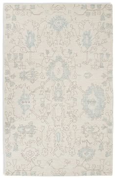 a white rug with blue and grey designs on the bottom, in front of a white background