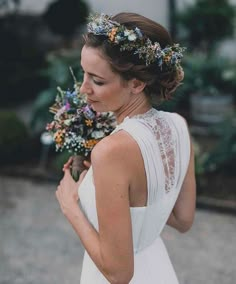 a woman in a white dress holding flowers