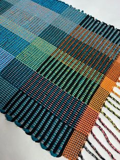 a multicolored table runner made out of different colored yarns and crochet