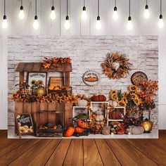 an autumn display with pumpkins, gourds and other decorations on the wall