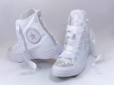 Bling CONVERSE CHUCK TAYLOR HIGH TOP in all white, canvas. *DESIGN for this listing: 💎 These Custom Jeweled Chucks Shine like DIAMONDS with Crystal CLEAR premium rhinestones 💎 TOES completely covered in clear gems 💎 HEELS with 3 rows of crystals down the back 💎 Crystals on the logos on the inner 2 sides - around the circle and the star 💎 Small laces loop blinged out as shown on top of tongue 💎 Comes laced with beautiful white ribbon, with original laces included in the shoebox *Sizes: Listed in Women's sizes *Additional Fees for ADD-ONS such as : Personalizations on the two outer sides (an ex. name is shown, dates, scattering crystals, hearts, etc. Message if you'd like to discuss your design and set up a custom order. Prices will vary by design. *Crystal color: Comes with CLEAR DIAM Chuck Taylors Wedding, Wedding Tennis Shoes, Bedazzled Converse, Personalized Converse, Tenis Converse, Converse Hi, White High Top Converse, Bling Converse, Wedding Converse