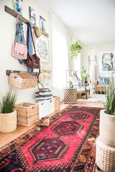 a living room filled with furniture and lots of rugs on top of a wooden floor