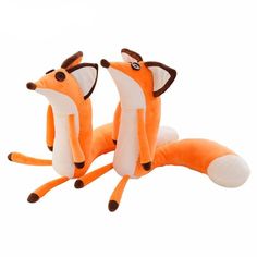 two stuffed foxes sitting next to each other