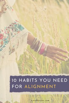 a woman in a field with the words 10 habitts you need for alignmentment