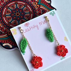 the earrings are made with crochet yarn and have flowers on each earring