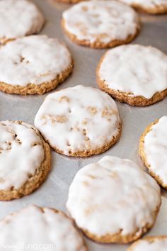 iced cookies with white icing on a baking sheet