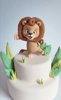 a white cake with a lion figurine on top