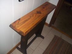 a wooden bench sitting on top of a tiled floor