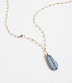 A pearl gemstone chain is accented by a pop of kyanite on this handcrafted necklace. The focal is a simple kyanite teardrop, wrapped by hand in gold filled wire. Simple Gemstone Necklace, Gemstone Necklace Ideas, 2024 Jewelry, Kyanite Necklace, Kyanite Earrings, Jewelry Men, Handcrafted Bracelets, Handcrafted Necklace, Stone Pendant Necklace