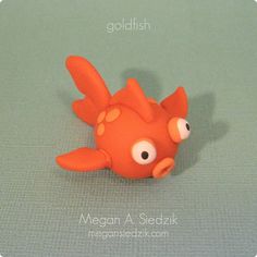 a close up of a toy fish on a green surface with the words collidish above it