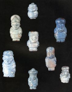 seven small ceramic figurines are displayed on a black background