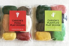 three bags of candy sitting next to each other on a white tablecloth with cactus's pizza play dough written on them