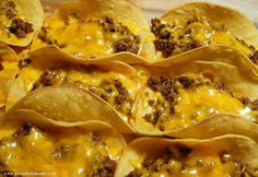 tortilla shells filled with cheese and ground beef