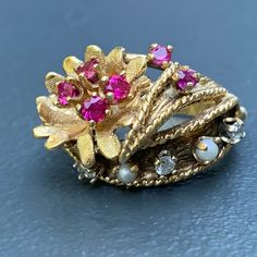 We take pride in finding unique , quality ~ Antique /Vintage jewelry pieces which are carefully hand picked by us so that you can add them to your treasure/ collection or gift to someone you love ~ We try to add plenty of items every week and have been selling online for more then 10 years . Vintage ~ 14kt yellow gold ~ Diamond ~ rubies ~ seed pearl ~ Cocktail /dinner ring ~ There are 6 small prong set faceted rubies , 3 diamonds and two seed pearls with applied wire work ~ Very well made ring . Vintage Gold Pearl Ring With Rose Cut Diamonds, Antique 14k Stamped Pearl Ring Gift, Vintage Pearl Ring With Rose Cut Diamonds For Gift, Vintage Pearl Ring With Rose Cut Diamonds As Gift, Vintage Pearl Ring With Gemstone, Vintage Gold Multi-stone Cluster Ring, Vintage Multi-stone Pearl Ring For Anniversary, Vintage Multi-stone Pearl Ring For Formal Events, Vintage Multi-stone Pearl Ring For Formal Occasions