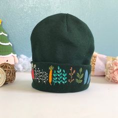 "The embroidered beanie hat is handmade one stitch at a time on the hat. It is embroidered only on the front. 🧶 Measurement: approximate 7\"-8\" in length. 🧶 Washable alone with the laundry bag, gentle or dedicated cycle. 🧶 DO NOT DRY by DRYER; HANG DRY ONLY! 🌸 Thanks for visiting my little shop, located in Pittsburgh, PA! Please do not hesitate to contact me if I could further assist/information on this item." Embroidered Winter Hats, Winter Cotton Bonnet Cap, Cotton Winter Bonnet, Fall Green Cotton Hat, Adjustable Cotton Winter Hat, Adjustable Cotton Hats For Winter, Green Cotton Beanie Cap, Winter Cotton Brimmed Hat, Casual Beanie With Embroidered Logo