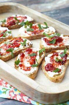 small pieces of bread topped with cheese and toppings