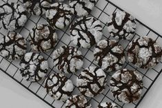 chocolate crinkle cookies on a cooling rack with powdered sugar